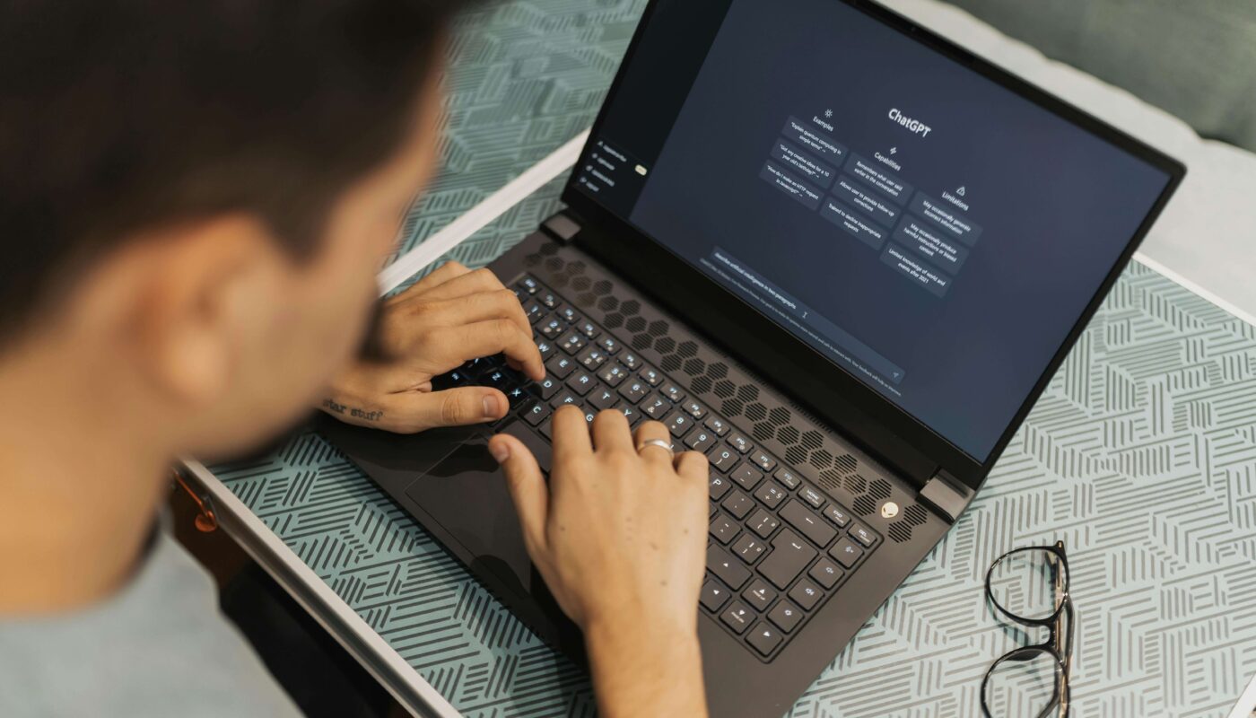 A product designer using AI tools on laptop for UI/UX design in 2025