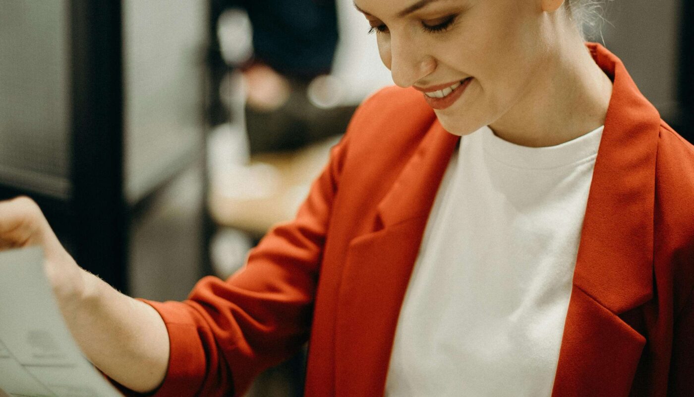 Designer receiving real-time AI feedback in Figma on laptop screen.