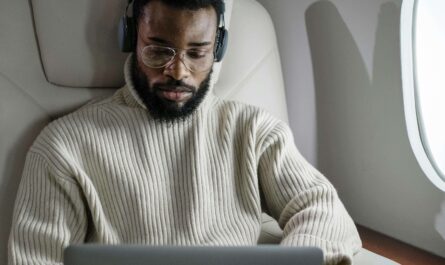 A designer wearing a VR headset is working on a laptop to build an AR/VR product prototype with AI tools.