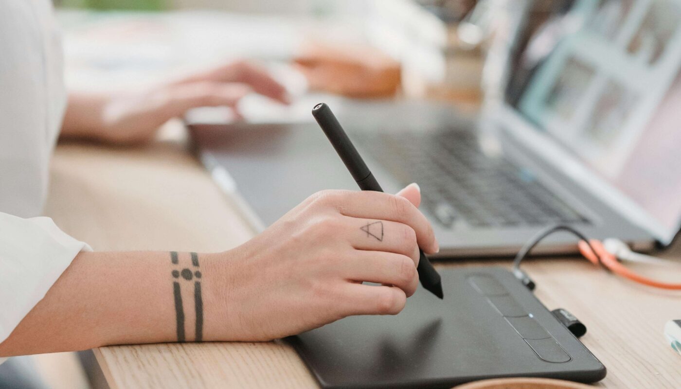 Designer creating AI-powered moodboard on laptop