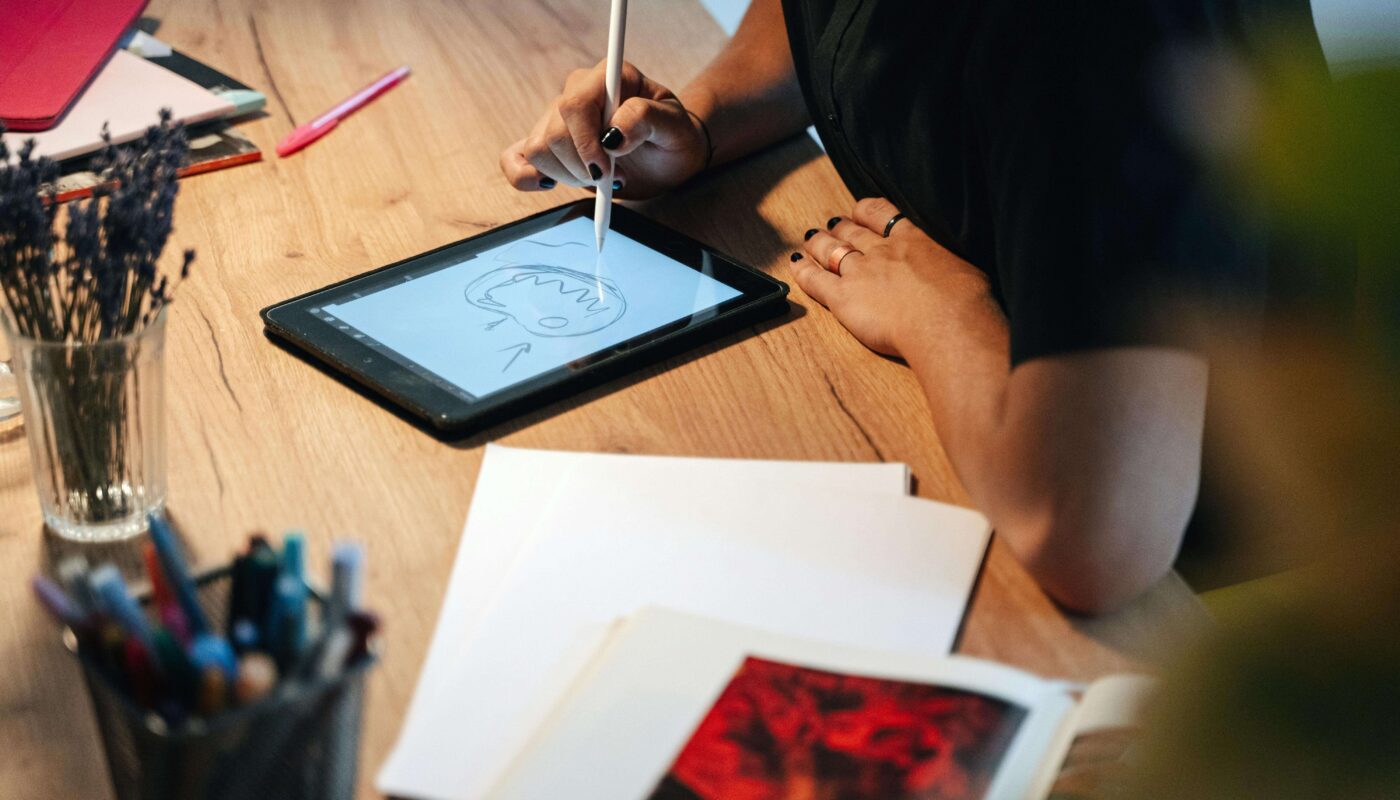 Product designer working in Sketch app with an AI plugin panel open on laptop screen.