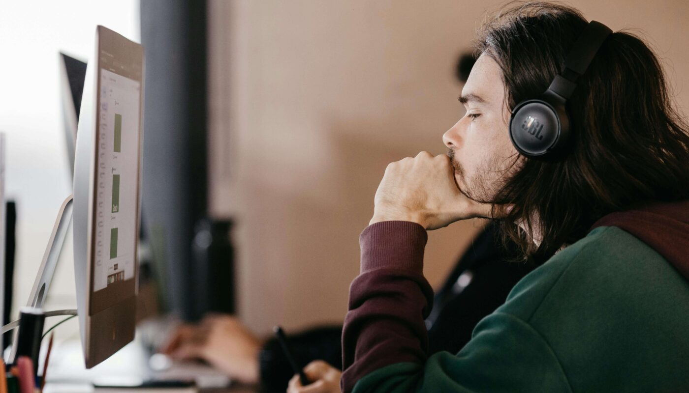 Product designer using AI tool on laptop for visual design