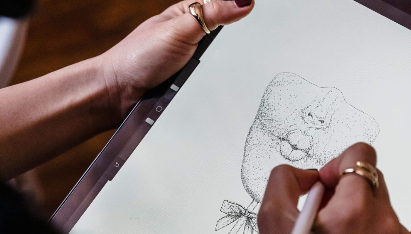 "Freelancer creating a digital illustration using an AI art generator on a laptop."