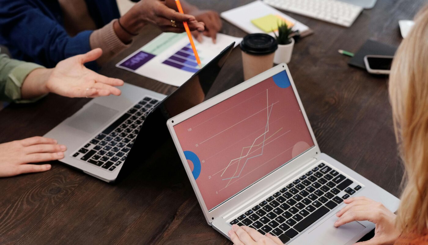 A UX designer working on a laptop to monitor website analytics and user behavior with an AI-powered dashboard.