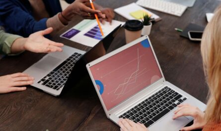 A UX designer working on a laptop to monitor website analytics and user behavior with an AI-powered dashboard.