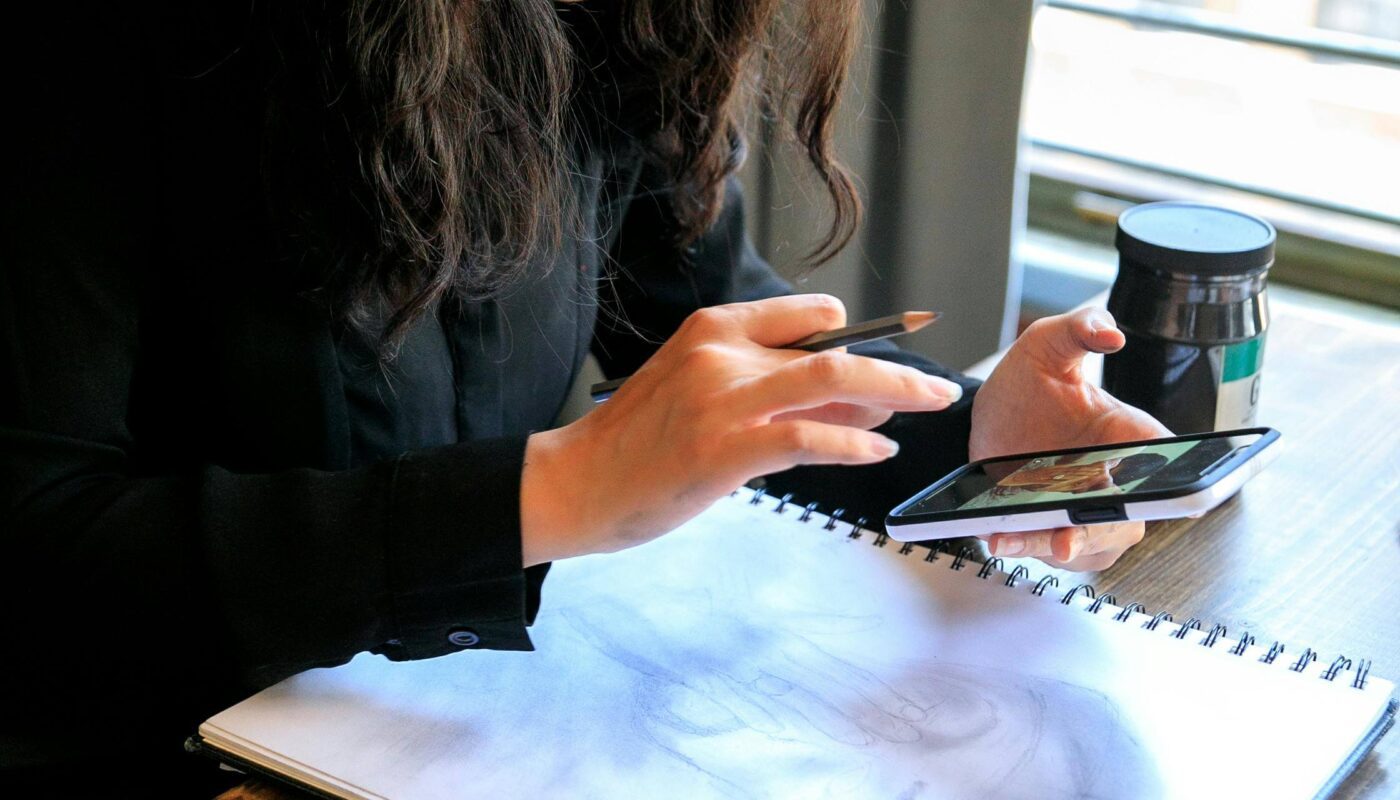 Person scanning a paper sketch to turn it into a digital prototype using AI