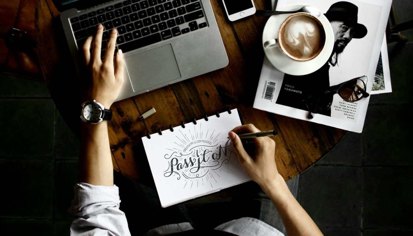 A product designer using AI tools on a computer in a creative workspace, optimizing workflows and design systems.