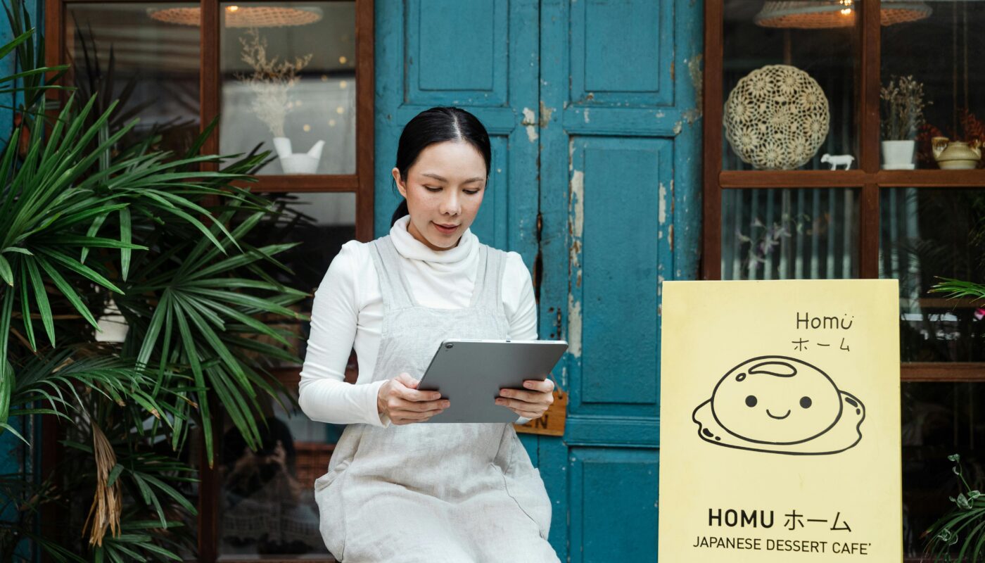 Government product designer using AI tools on laptop to create digital public service designs and dashboards.