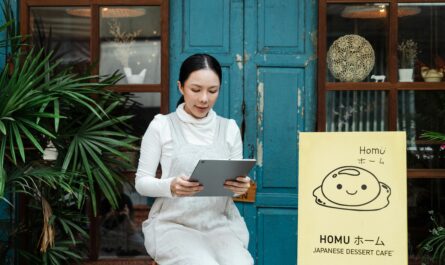 Government product designer using AI tools on laptop to create digital public service designs and dashboards.