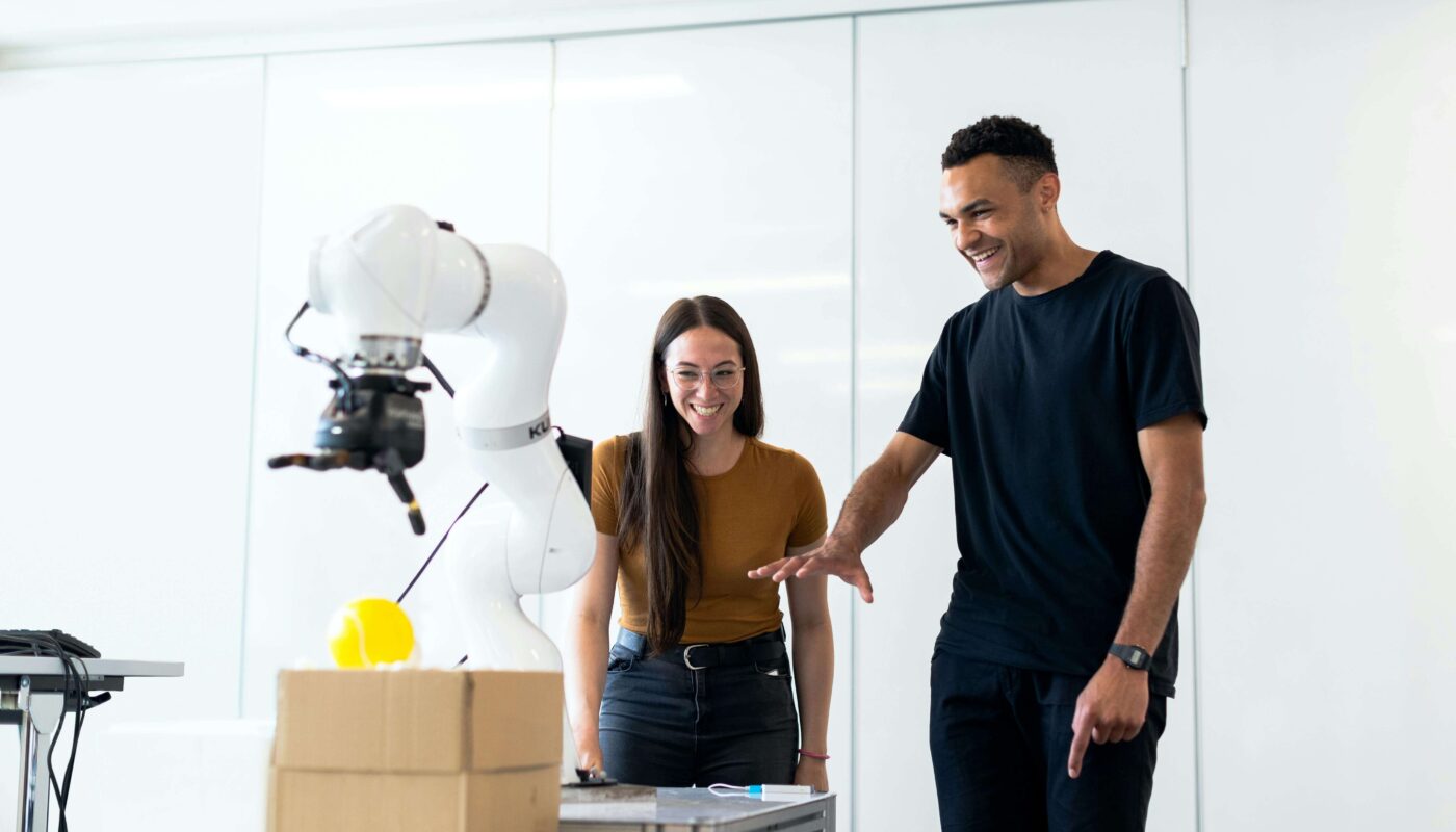 Designer using AI tools to compare A/B testing design variations on laptop